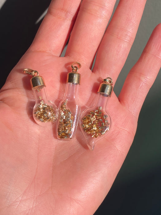 14k glass bottle with moving silver pieces inside charm pendant