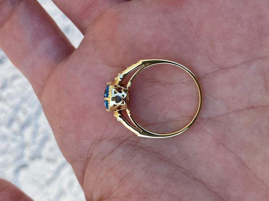18K Gold Blue Topaz & Diamond Halo Ring